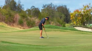 Golfer concentrating on a putt, illustrating golf sports psychology